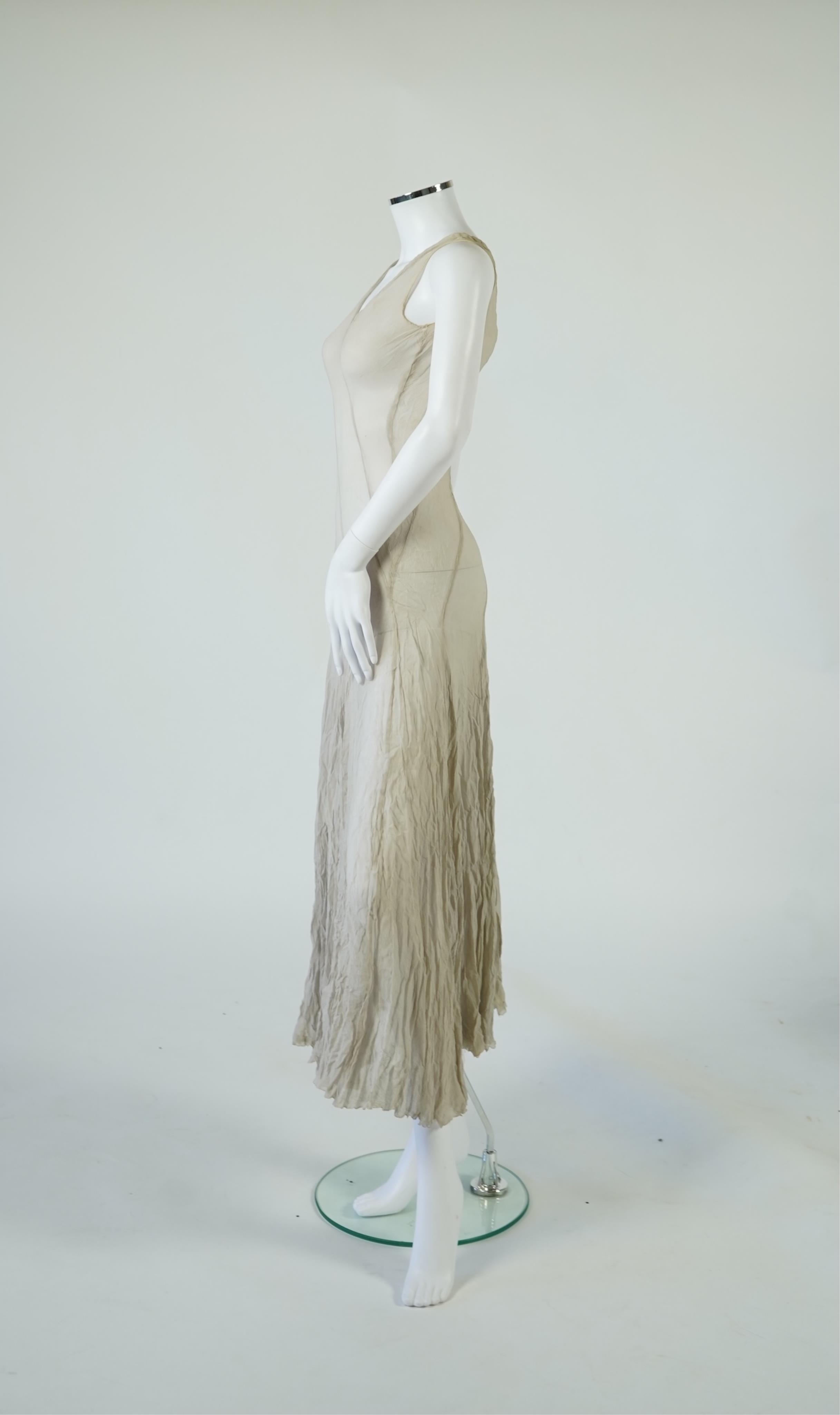 A 1930's grey chiffon bias cut ladies evening dress. 120cm long. Condition - has a small hole at the back and a light mark possibly removed with washing.